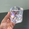 نمای نزدیک از لیوان دفرمه دنی هوم طرح هفت رنگ که در دست نگاه داشته شده است.