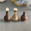 رنگ‌های مختلف از محصول گلدان چوبی کوزه‌ای مدل مینیاتوری در کنار یکدیگر