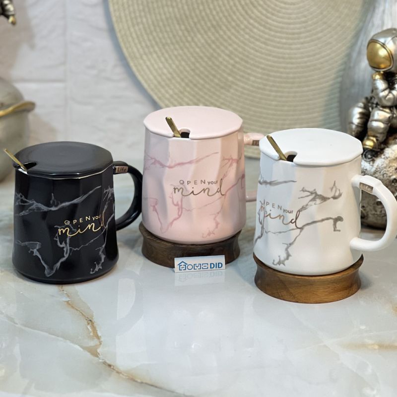 Luxury mug with marble design with golden writing along with lid and spoon