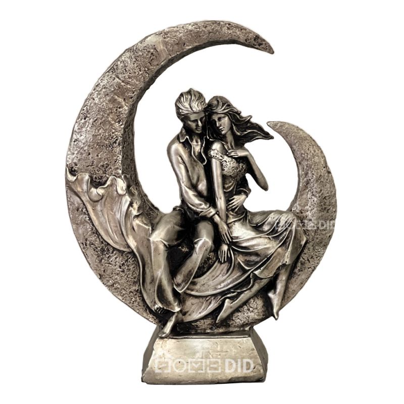 statue of a man and a woman with a moon rider design